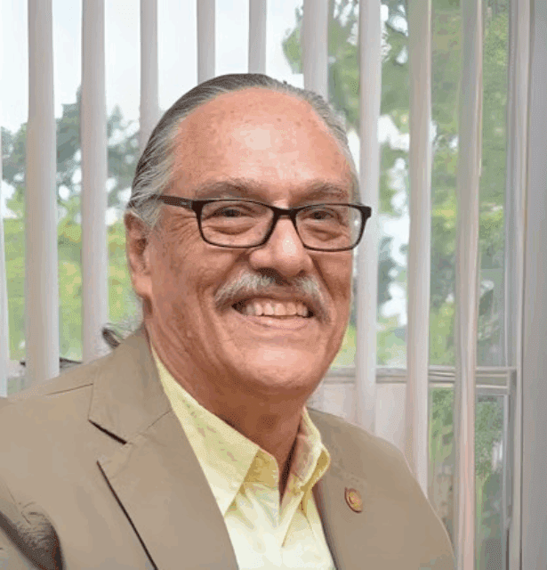 A professional headshot of Armando Caceres, a speaker at the 3rd WCTCIM. The Chemical Biologist from Guatemala is in formal attire.