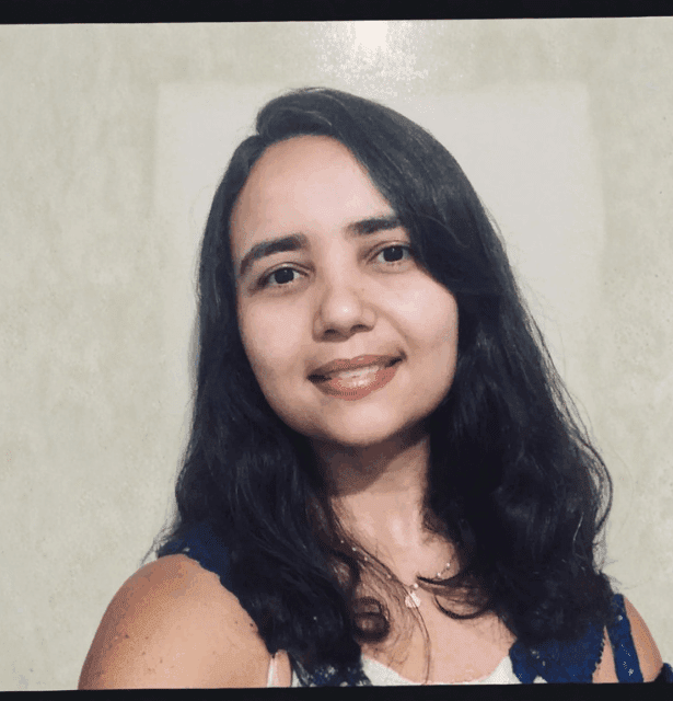 Professional headshot of speaker Adriana Passos. She has a neutral expression and is dressed in professional attire for her profile.