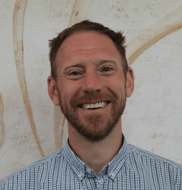 Professional headshot of Kieran Cooley, Director of Research at the Canadian College of Naturopathic Medicine, smiling slightly.