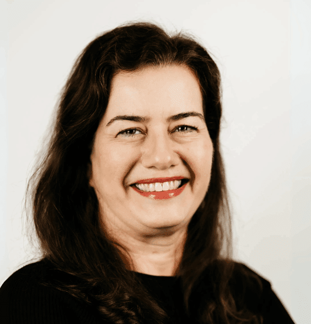 A professional headshot of Mariana Villela, an architect and PhD student researching integrative health environments.